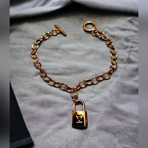 Petite lock on a stainless steel gold plated bracelet